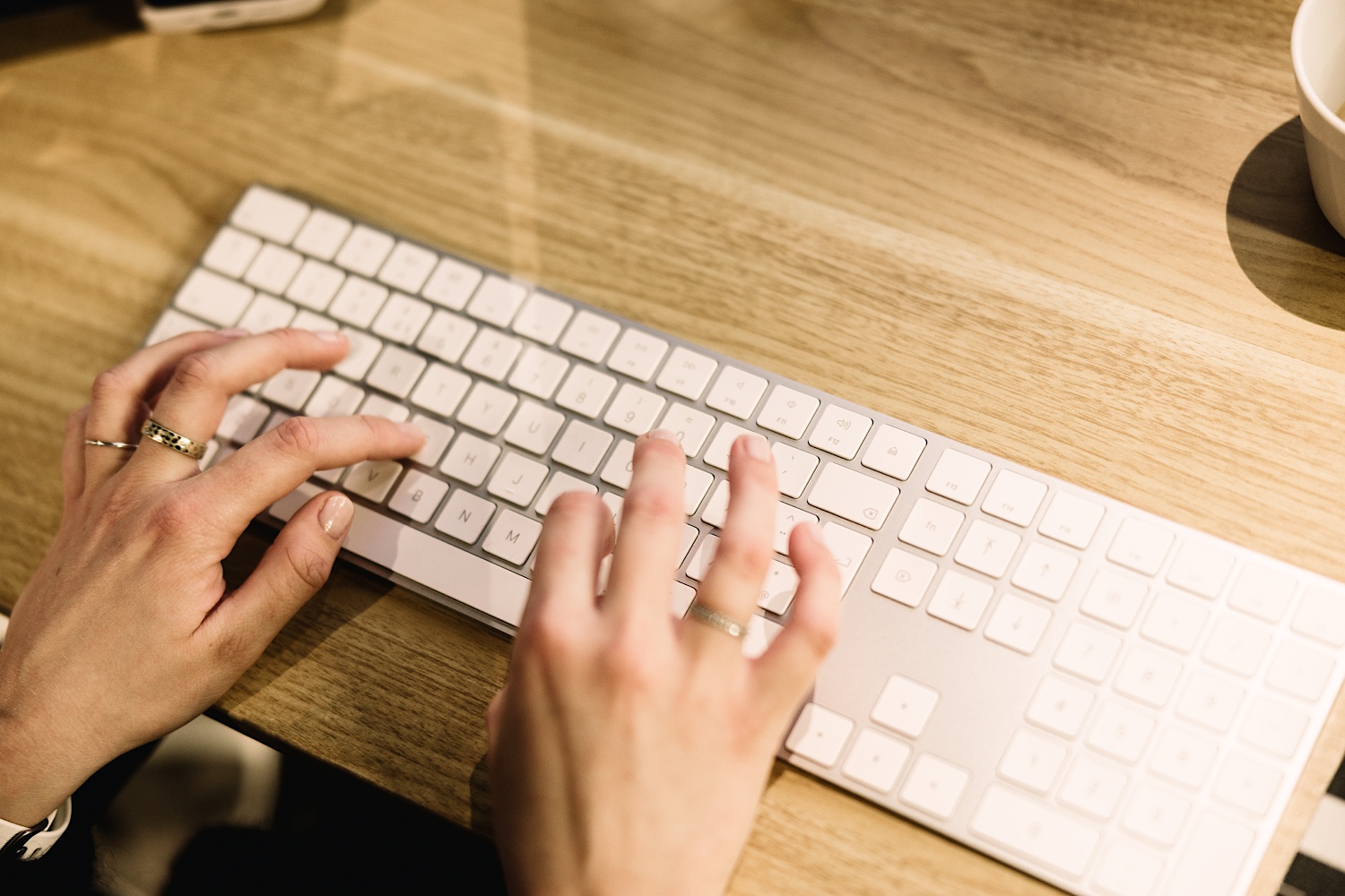 Hands typing on a keyboard